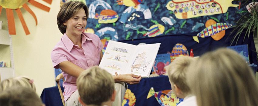 Teacher reading a book to the class.